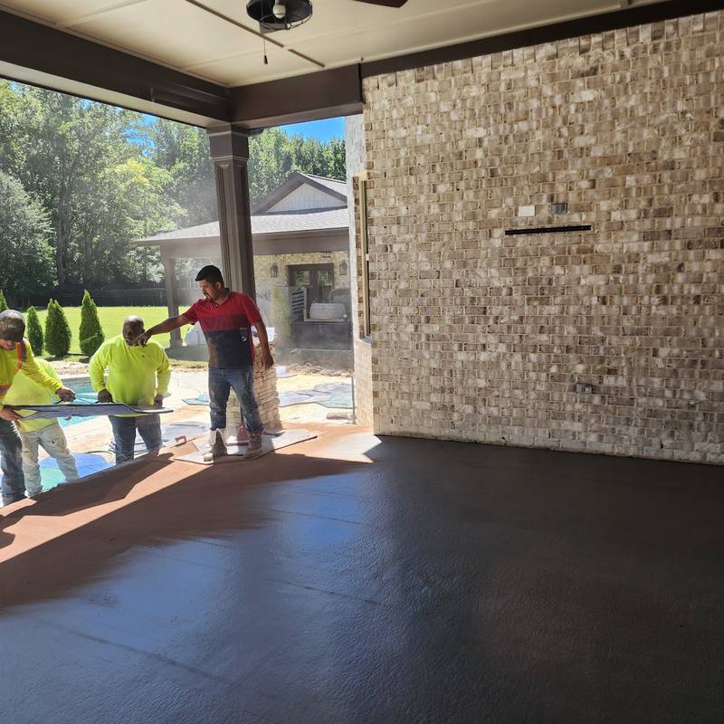 Crew working on a covered concrete patio