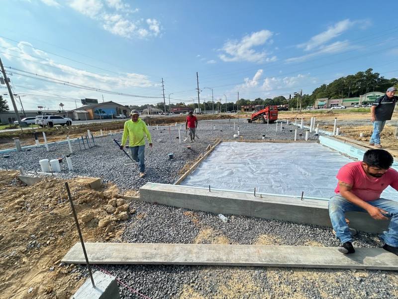 Crew finishing a large concrete slab