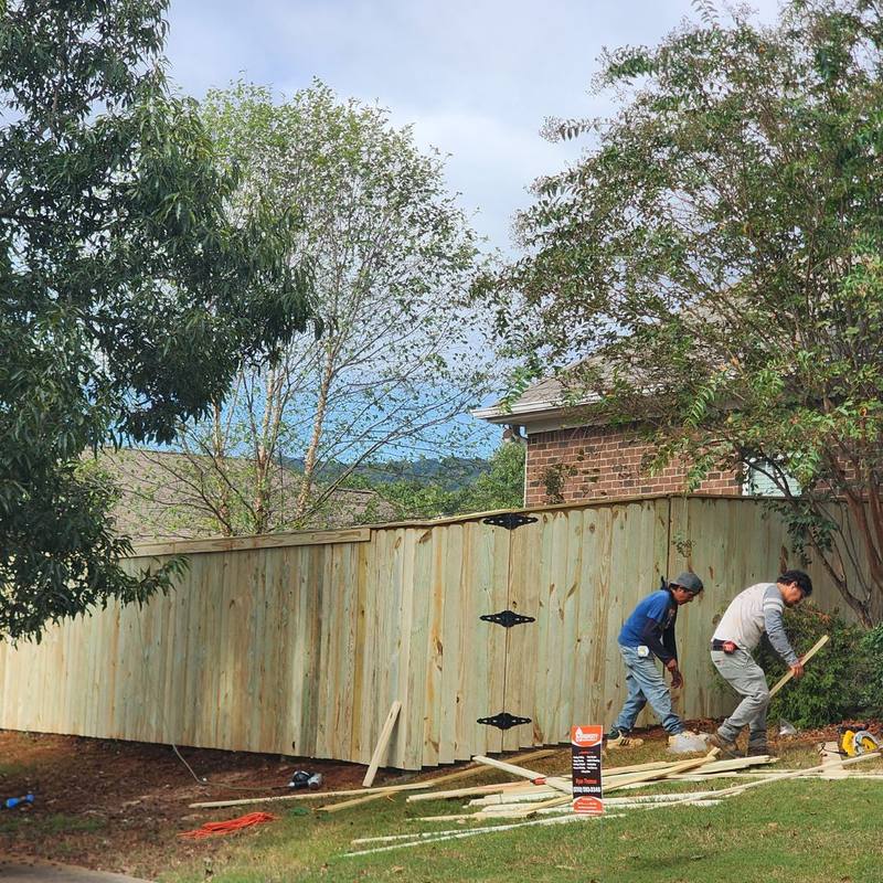 Crew installing a new wood privacy fence in Owens Cross Roads, AL