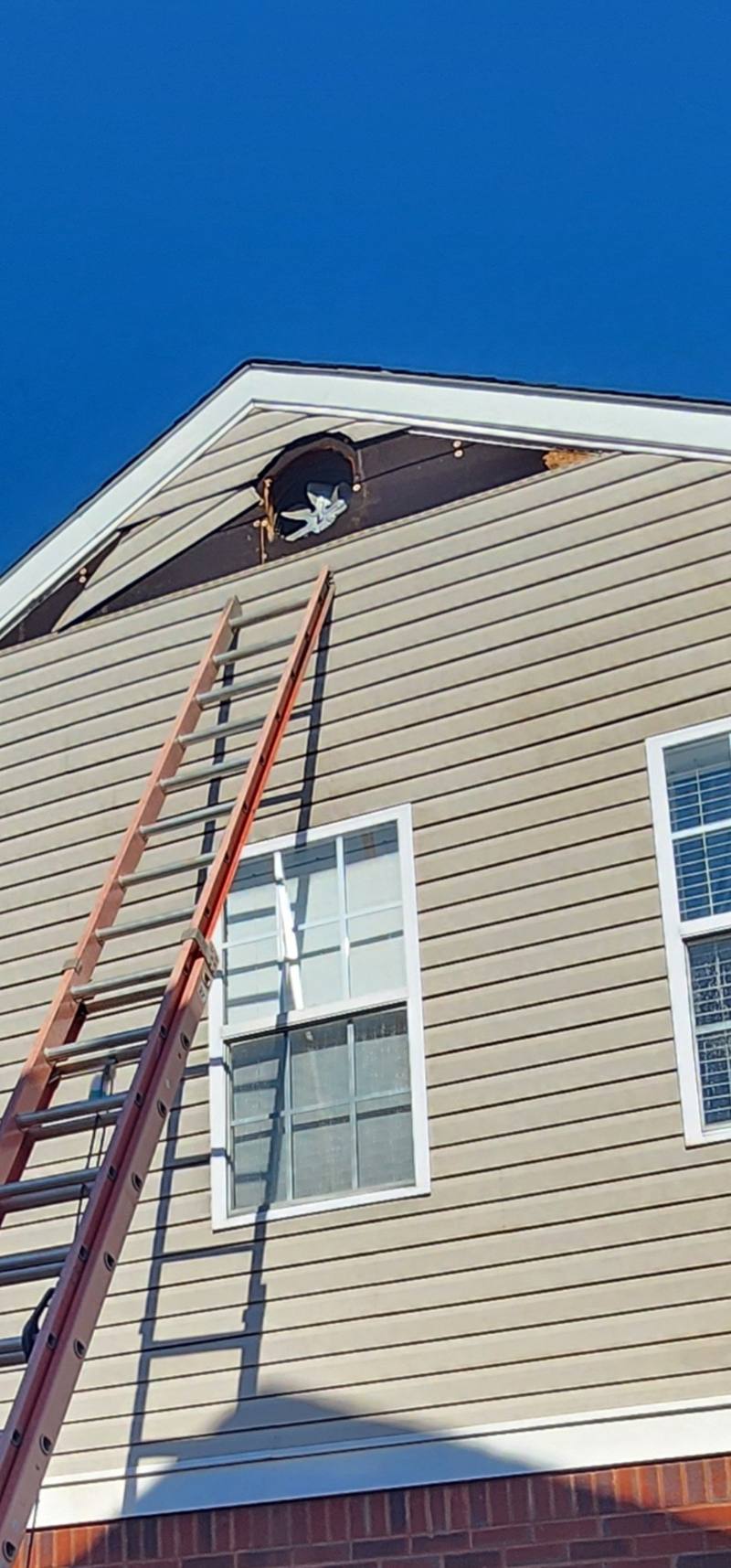 Storm-damaged gable siding before repair in Owens Cross Roads, AL