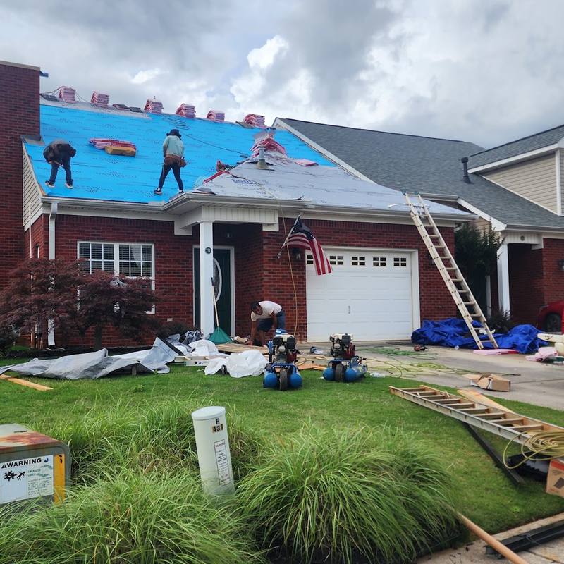 Roof replacement in progress on a brick home in North Alabama