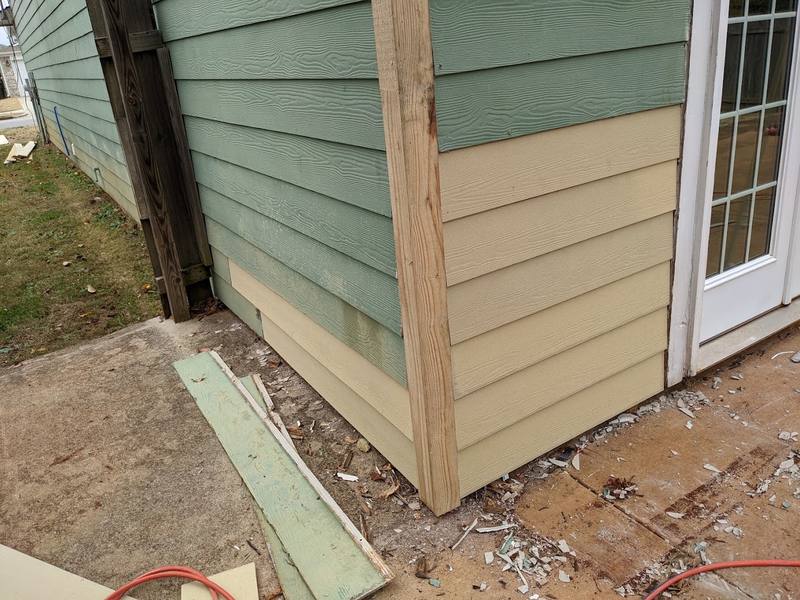 New siding boards installed beside a French door