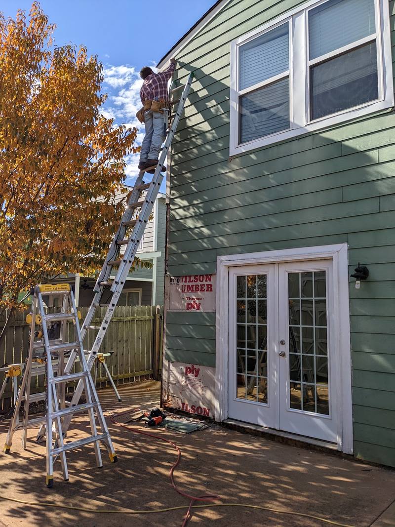 Siding repair on a two-story home in Huntsville, AL