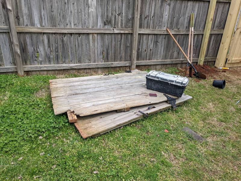 Old fence boards removed during a wood fence repair